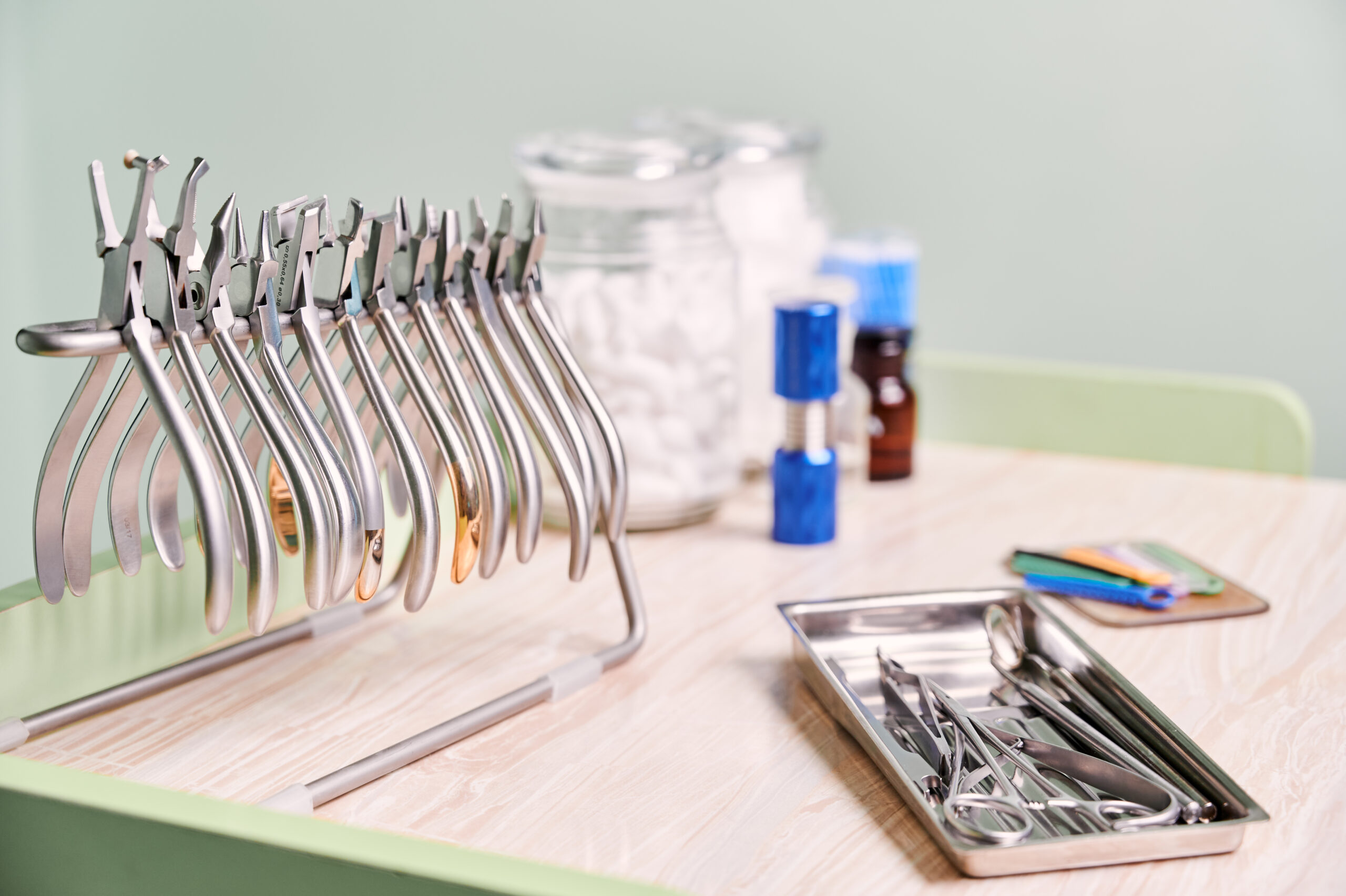 Table with orthodontic instruments for dental procedure.